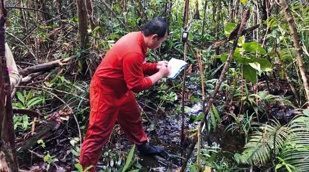 Mapping forests helps indigenous people defend their land Matek surveying a forest